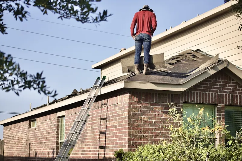 Professional roofer working on a residential roof in Artesia Pilar